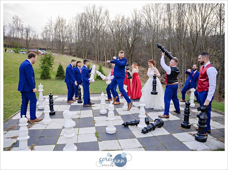 Bridal party playing with large chess set at Rivercrest Farm in Ohio