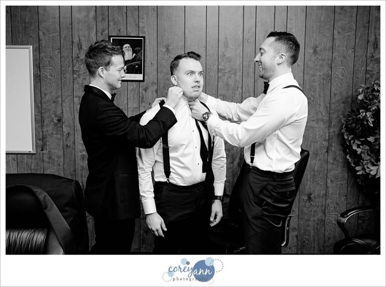 Silly groom and groomsman getting ready for wedding ceremony in Canton Ohio