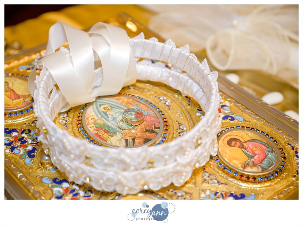 Crowns and rings on gold bible before greek wedding in Canton Ohio