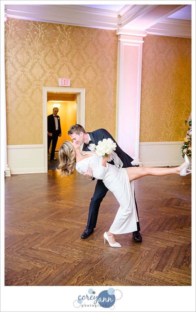 Groomsman dipping bridesmaid during entrance to wedding reception