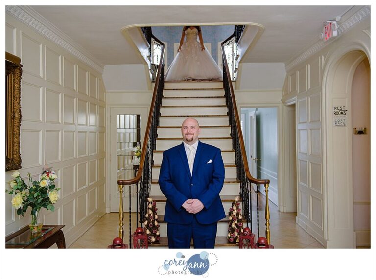 Groom waiting for bride before first look at Henn Mansion on their wedding day