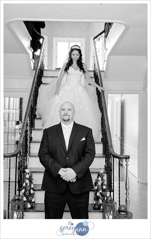First Look on stairs at Henn Mansion on a wedding day in February