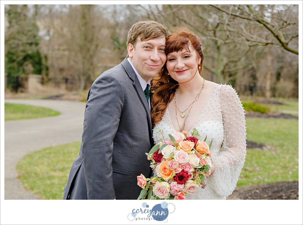 Bride and Groom smiling on a windy cold March wedding day