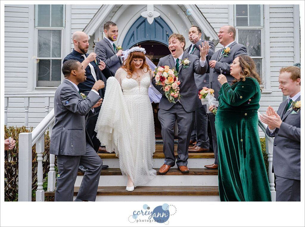 Bride and groom exiting from Mother of Sorrows in Peninsula Ohio to bubbles on their wedding day