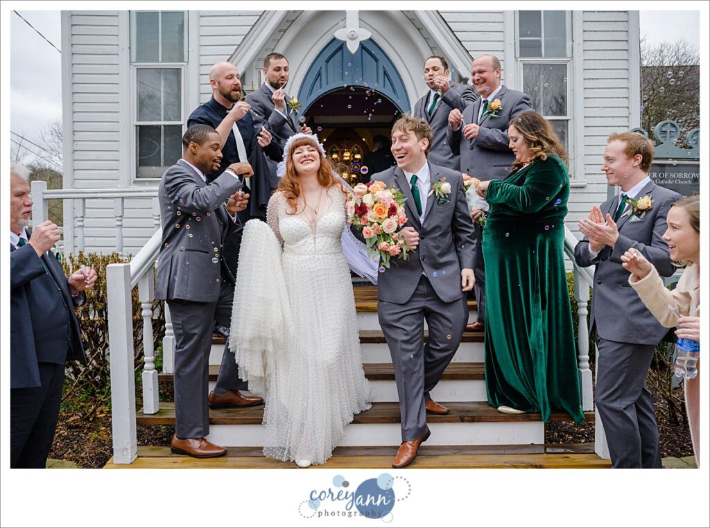 Bride and groom exiting from Mother of Sorrows in Peninsula Ohio to bubbles on their wedding day