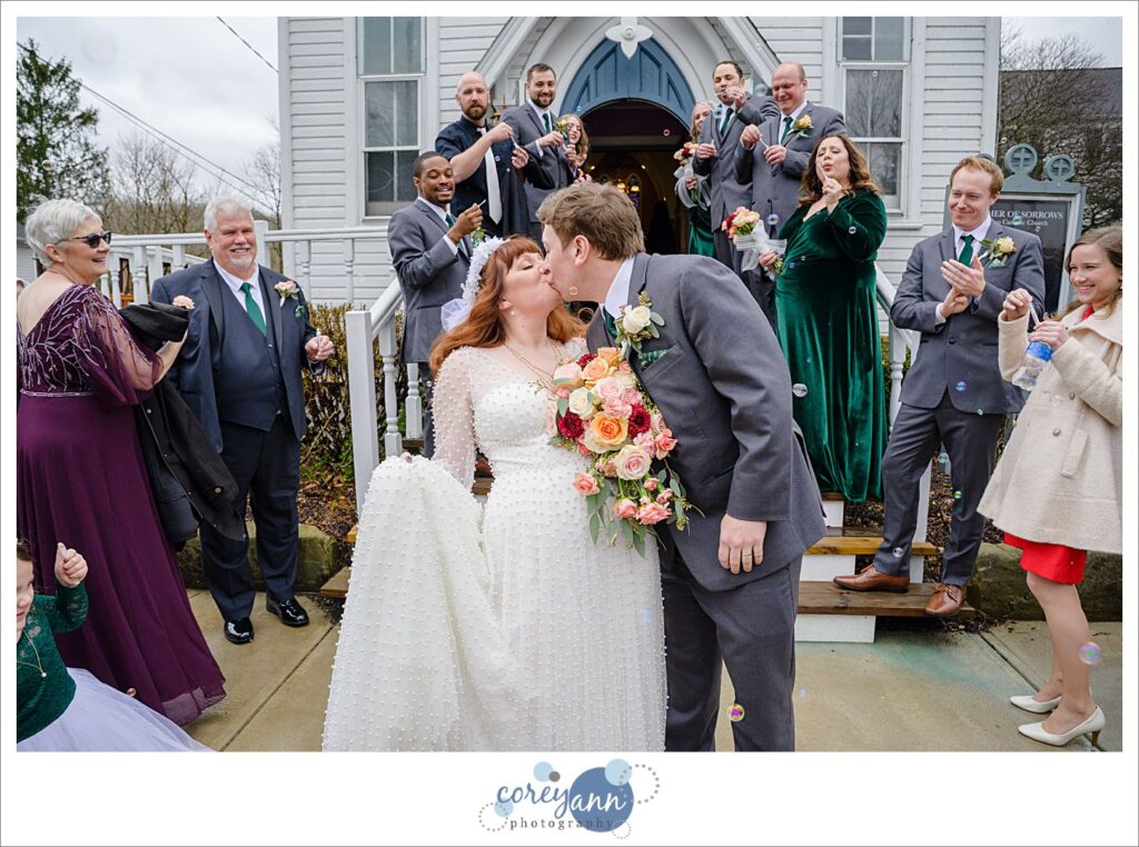 Bride and groom exiting from Mother of Sorrows in Peninsula Ohio to bubbles on their wedding day