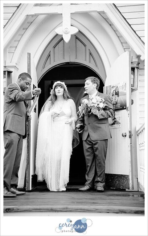 Bride and groom exiting from Mother of Sorrows in Peninsula Ohio to bubbles on their wedding day