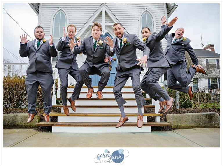 Groom and groomsman jumping in a fun bridal party photo