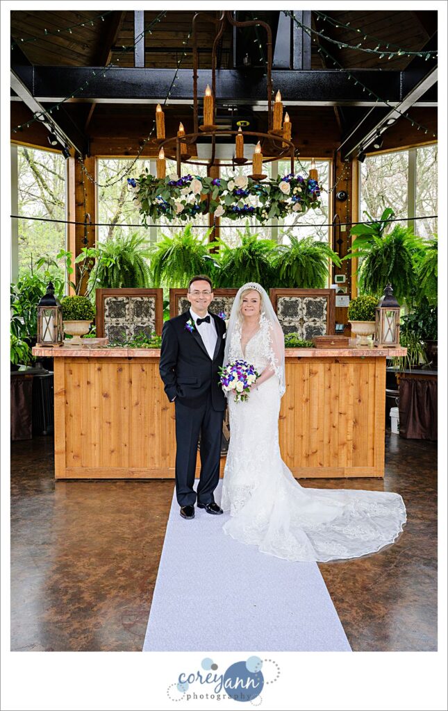 Bride and groom portrait in the conservatory at Gervasi Vineyard