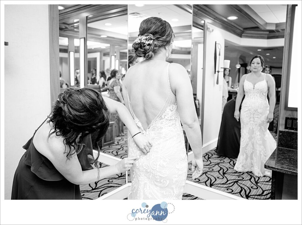 bridge getting ready for wedding at firestone country club