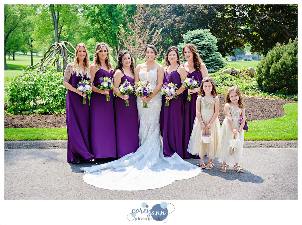 Bride and Bridesmaids in dark purple dresses at Firestone Country Club in Akron Ohio