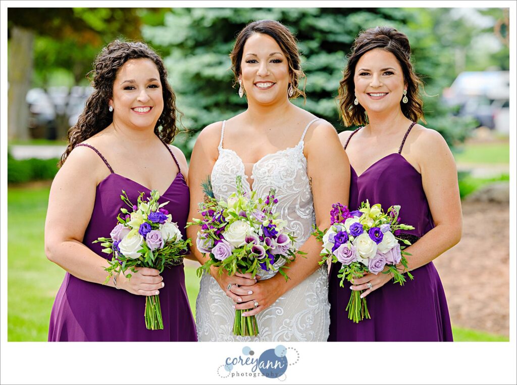 Bride and Bridesmaids in dark purple dresses at Firestone Country Club in Akron Ohio
