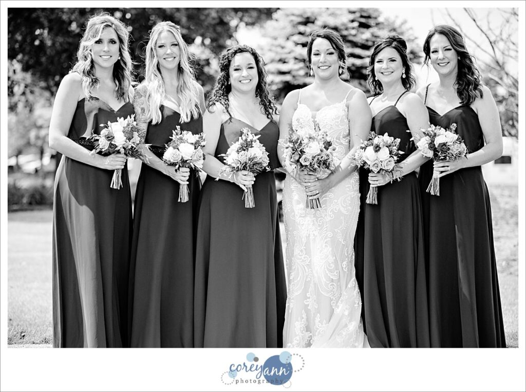 Bride and Bridesmaids in dark purple dresses at Firestone Country Club in Akron Ohio