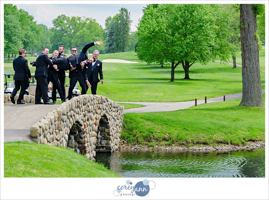 Groom and groomsman in black tuxes at a Firestone Country Club Wedding in Akron Ohio