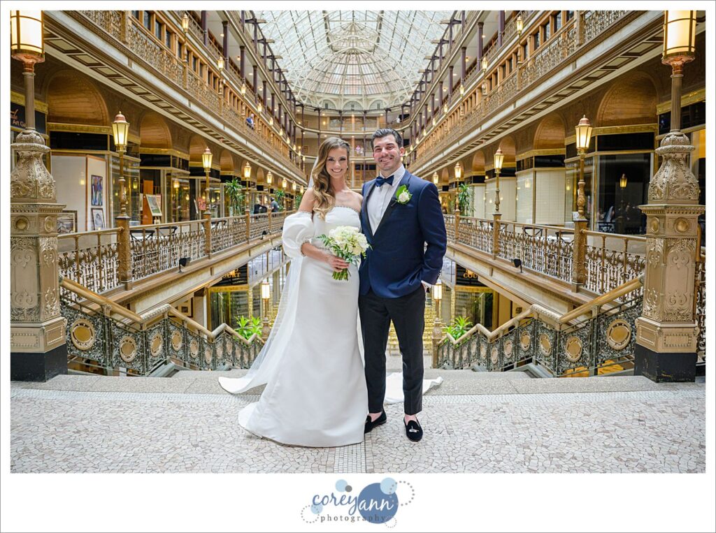 Bride and Groom standing inside the arcade in Cleveland before wedding