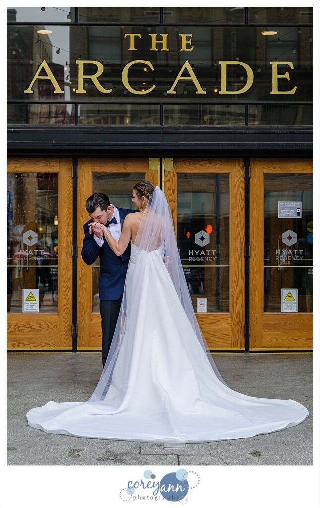 Groom kissing bride's hand in Downtown Cleveland Ohio