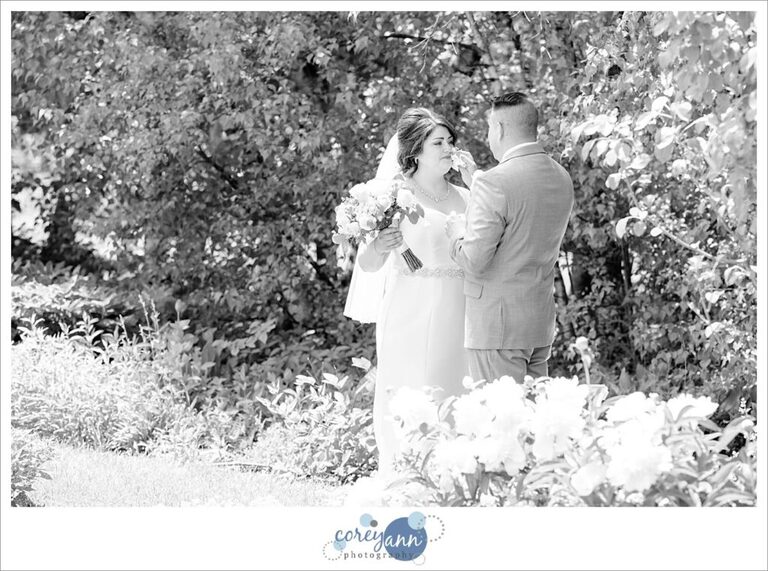groom wiping tear from bride's eye after ceremony at stan hywet