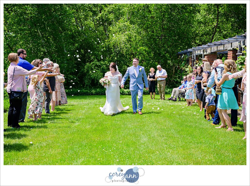 Bride and groom petal exit in the great garden at Stan Hywet after wedding ceremony