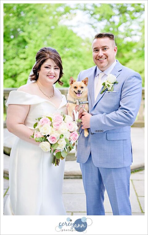 bride and groom with their flower dog at stan hywet in akron ohio