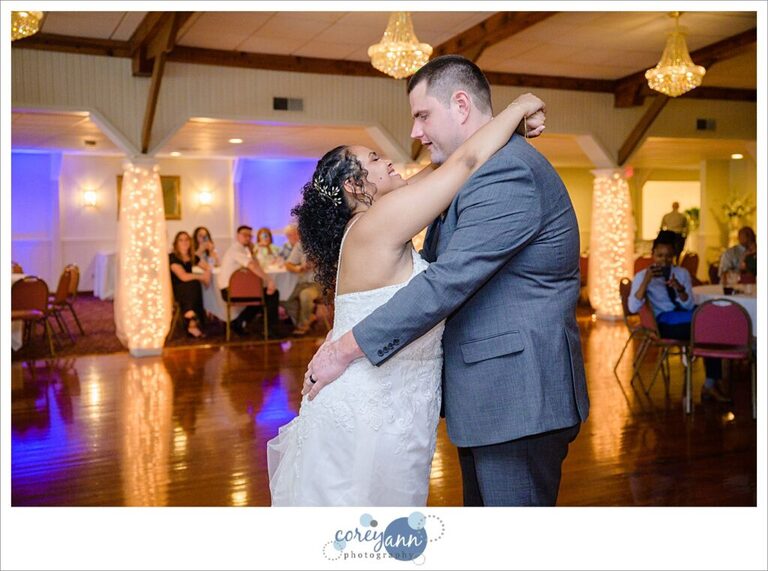 Bride and groom kissing during their first dance at their wedding reception in Akron Ohio