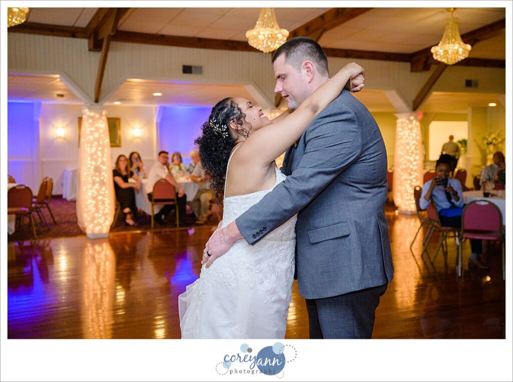 Bride and groom kissing during their first dance at their wedding reception in Akron Ohio