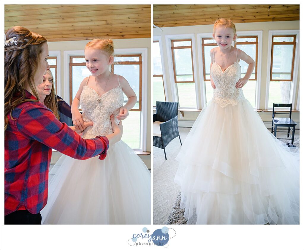 Bride's young daughter trying on her wedding dress before the event at Amy's Rustic Event Center in Valley City Ohio