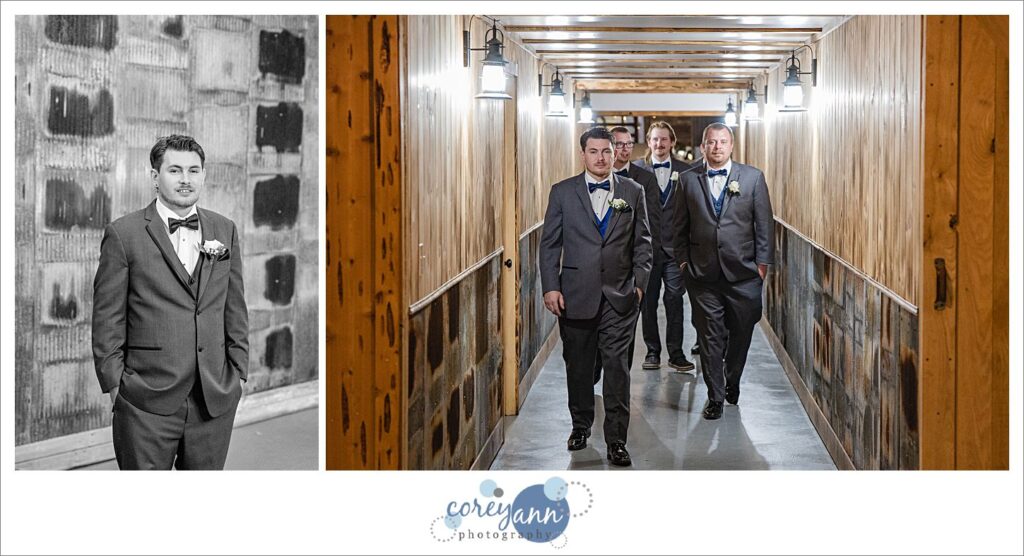 Groom and groomsman in charcoal tuxes walking the hallway at Amy's Rustic Event Center in Valley City, Ohio
