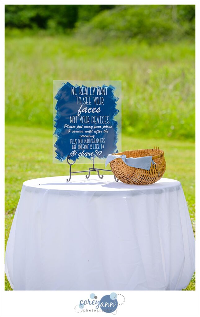 Acrylic unplugged wedding sign on a table outside of the ceremony area at Amy's Rustic Event Center in Valley City, Ohio