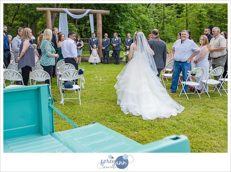 Bride walking down the aisle to her groom at Amy's Rustic Event Center in Valley City Ohio for a June wedding