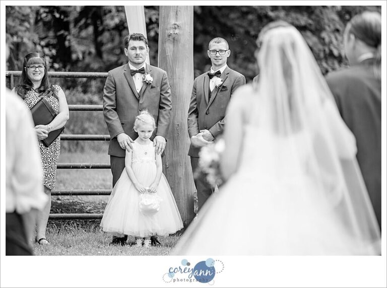 Bride walking down the aisle to her groom at Amy's Rustic Event Center in Valley City Ohio for a June wedding