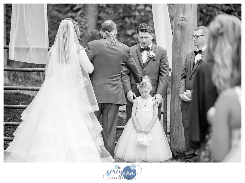 Bride walking down the aisle to her groom at Amy's Rustic Event Center in Valley City Ohio for a June wedding