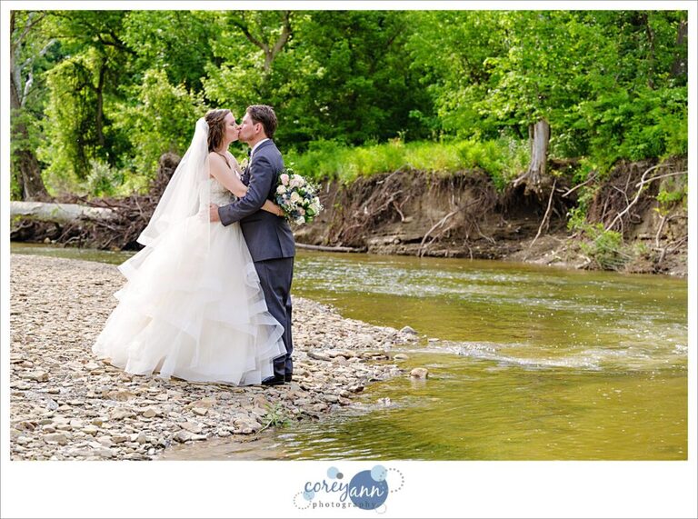 Bride and groom posing near Rocky River in Valley City Ohio