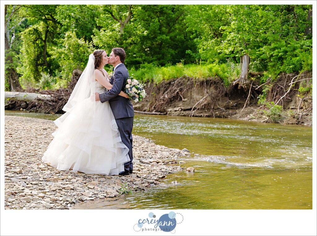 Bride and groom posing near Rocky River in Valley City Ohio