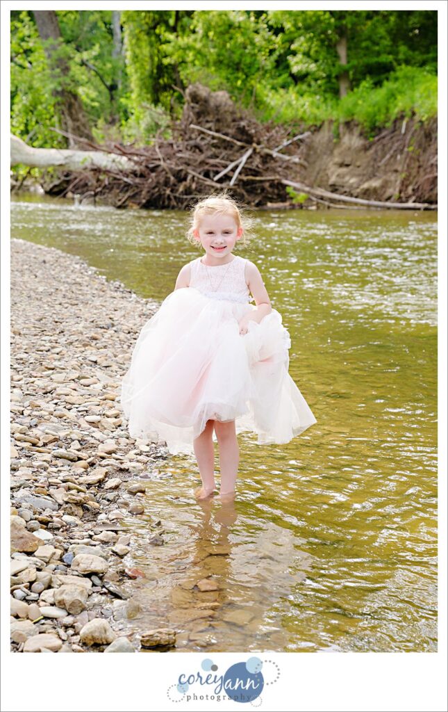 flower girl standing in river in valley city ohio