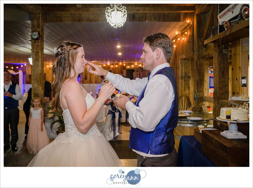Bride and groom cutting the cake at wedding reception at Amy's Rustic Event Center in Valley City, Ohio