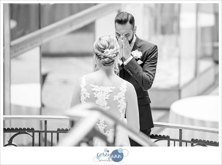 Groom trying not to cry when seeing bride for the first time before wedding in Cleveland at The Arcade