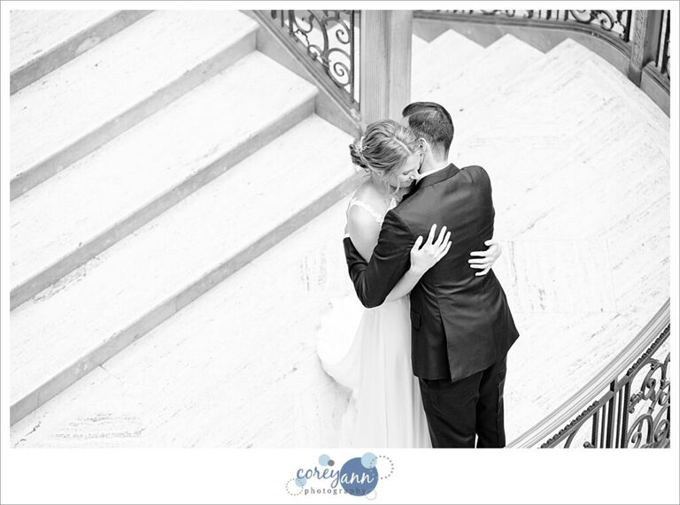 Bride and groom embrace after first look at Hyatt Regency Cleveland at The Arcade