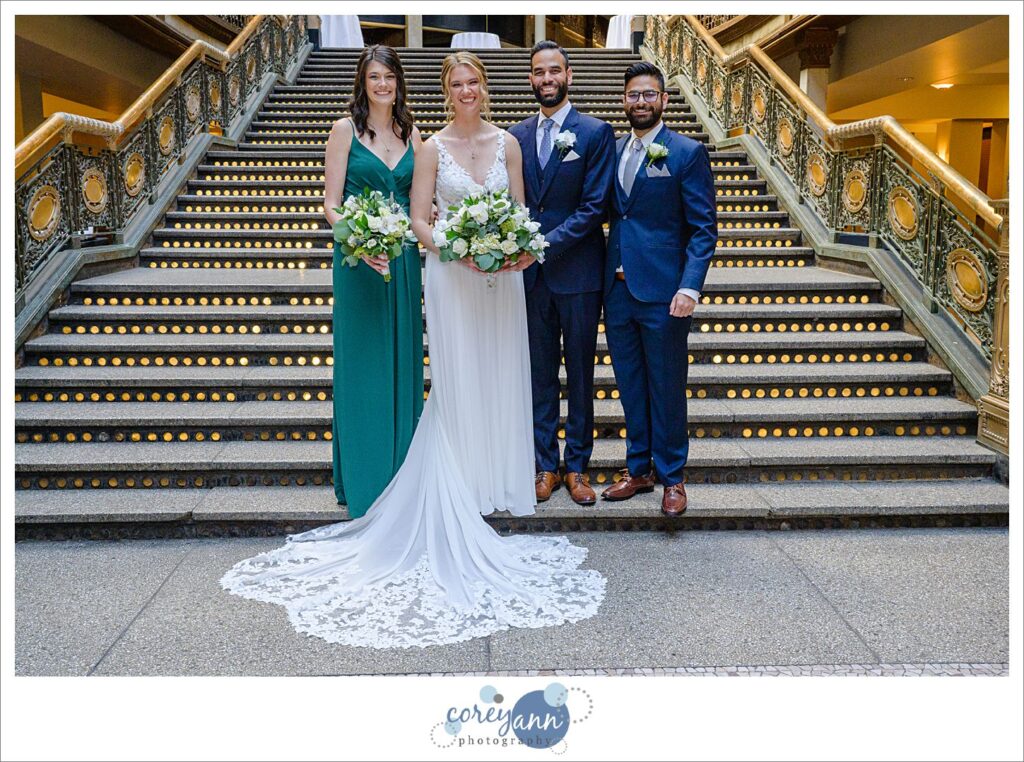 Small bridal party standing on the lit staircase at the Hyatt Regency Cleveland at The Arcade in Ohio