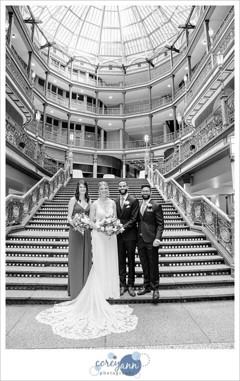Small bridal party standing on the lit staircase at the Hyatt Regency Cleveland at The Arcade in Ohio