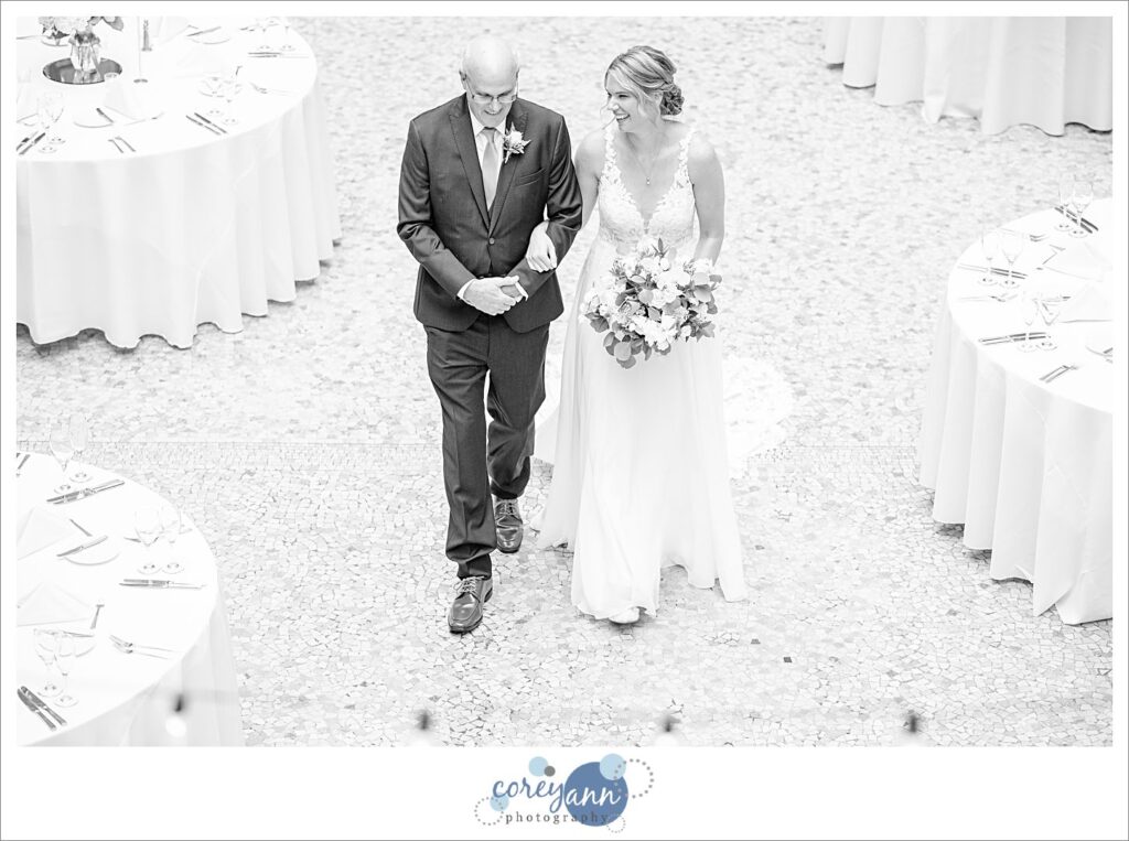Bride walking down the aisle to wedding ceremony at Hyatt Regency Cleveland at The Arcade