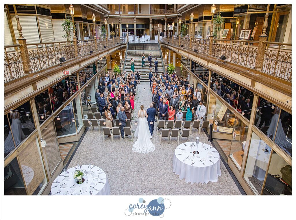 Bride walking down the aisle to wedding ceremony at Hyatt Regency Cleveland at The Arcade