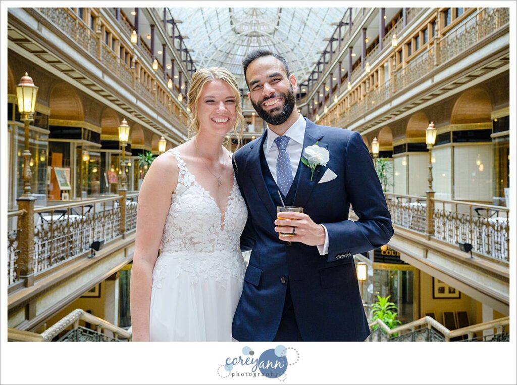 Bride and groom smiling during cocktail hour at Hyatt Regency Cleveland at The Arcade 