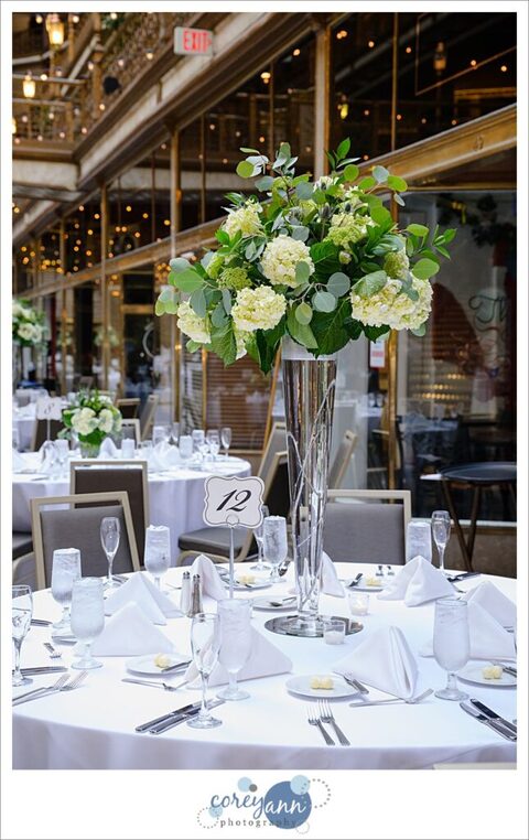 Elegant white and green wedding reception decor at Hyatt Regency Cleveland at The Arcade 