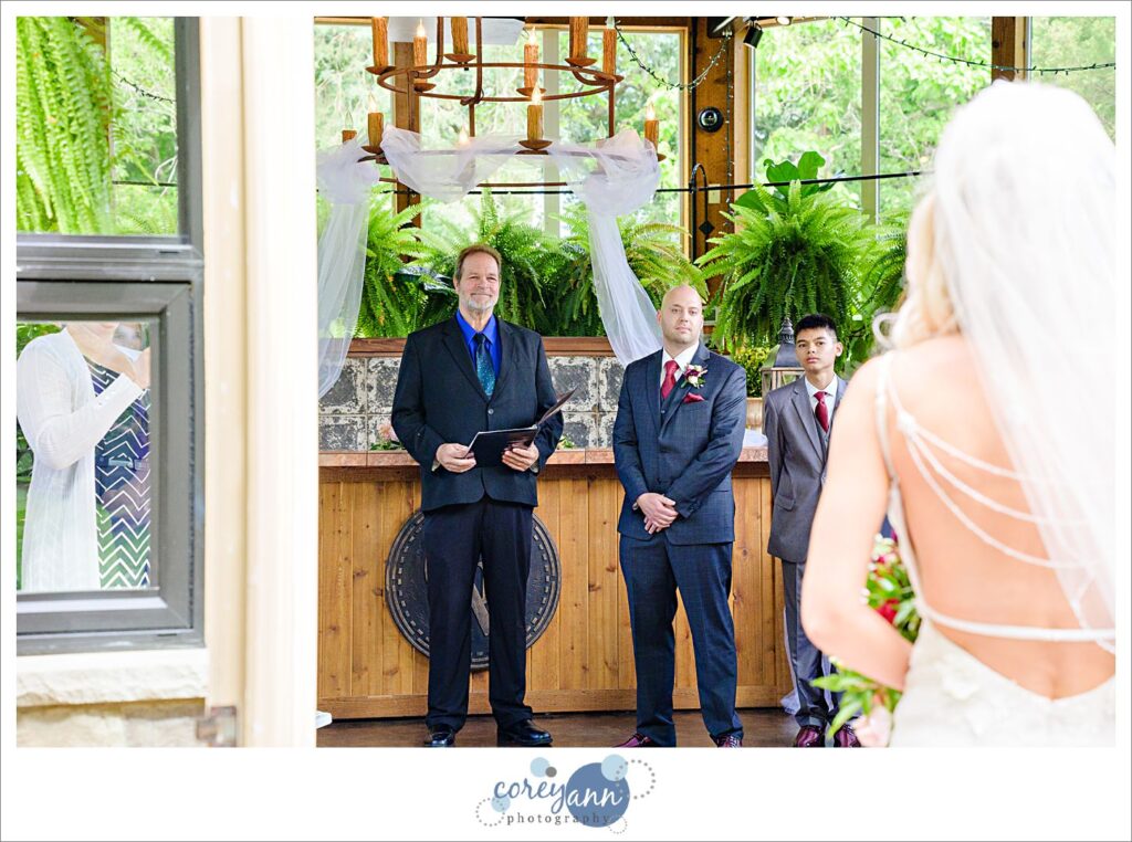 Groom seeing bride for the first time as she walks down the aisle in Canton Ohio
