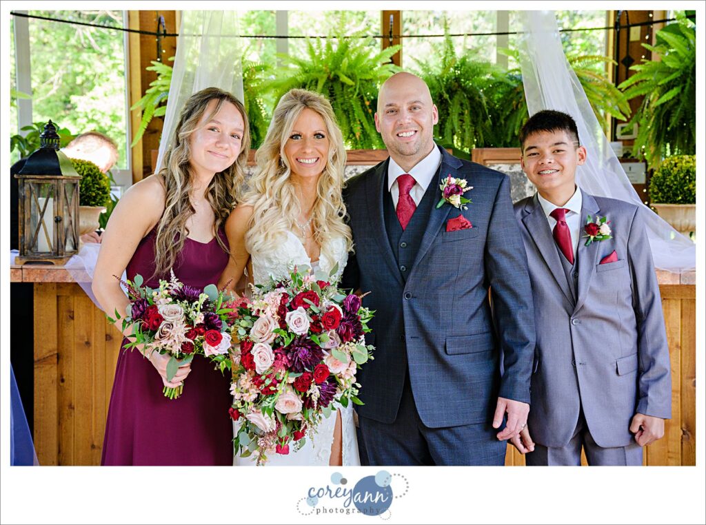 Family posing for a portrait with the bride and groom after their wedding ceremony at Gervasi