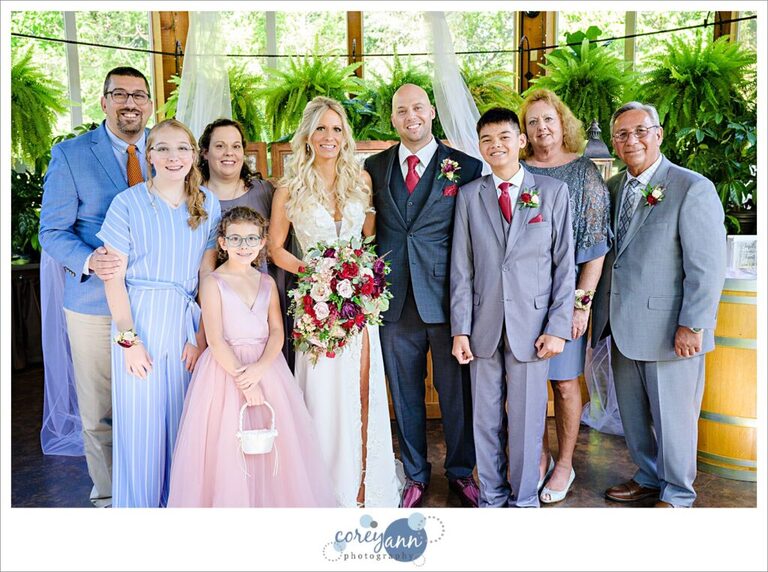 Family posing for a portrait with the bride and groom after their wedding ceremony at Gervasi