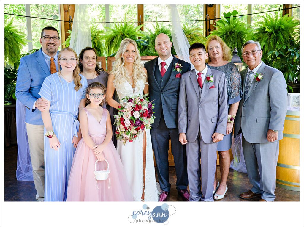 Family posing for a portrait with the bride and groom after their wedding ceremony at Gervasi