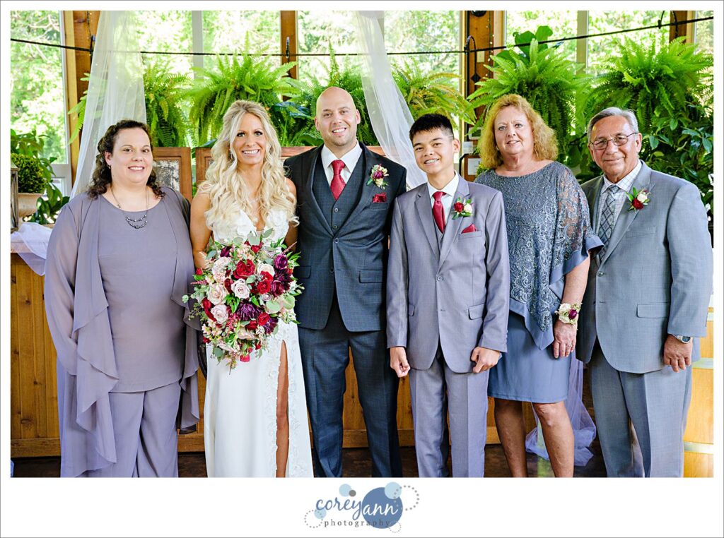 Family posing for a portrait with the bride and groom after their wedding ceremony at Gervasi