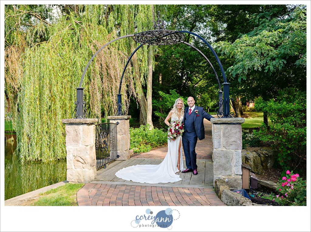 Bride and groom standing on the bridge at Gervasi Vineyard