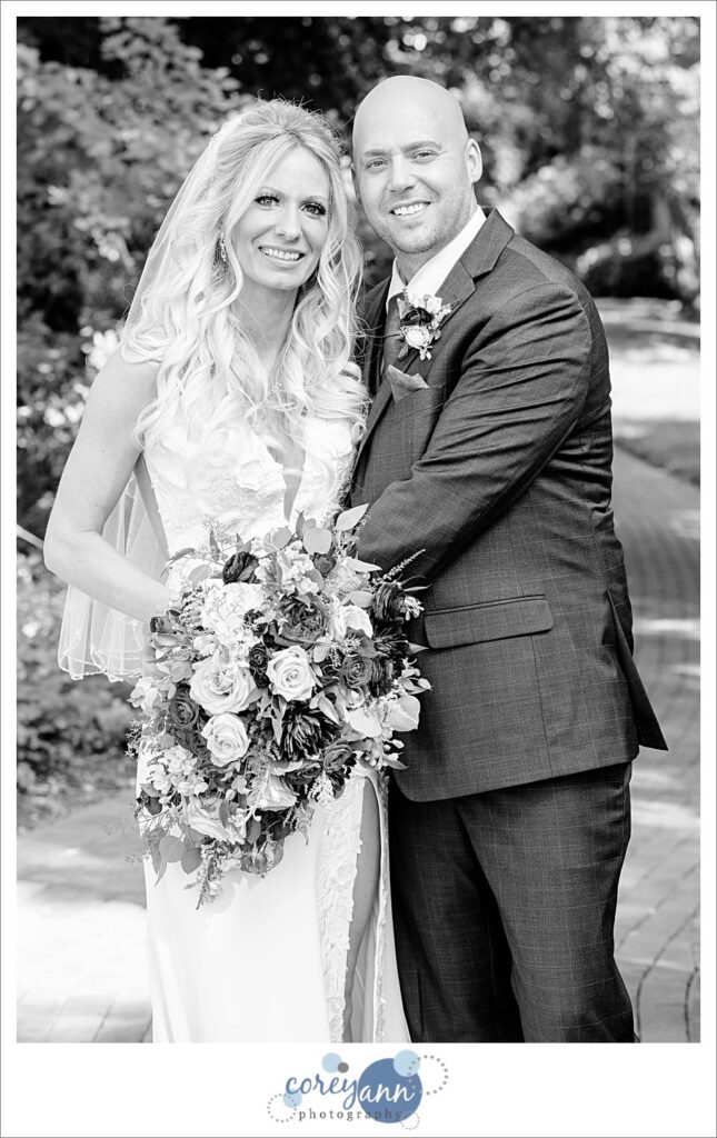 Bride and groom standing on the bridge at Gervasi Vineyard